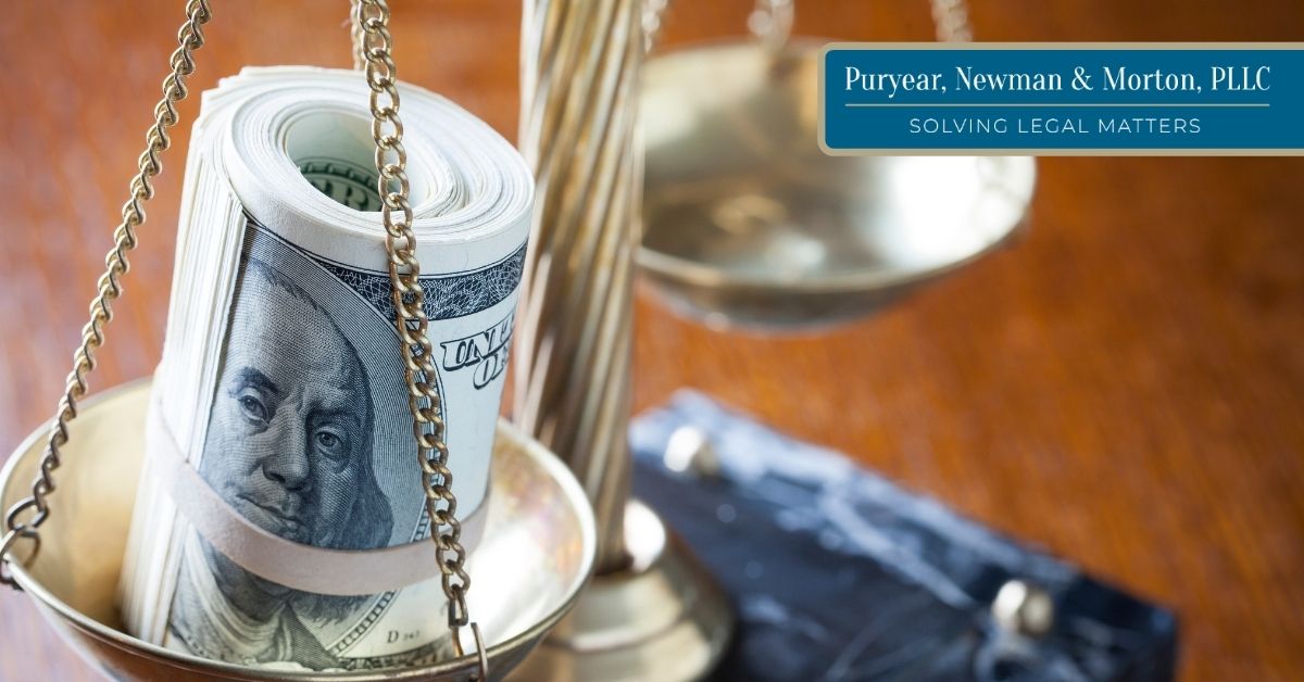 $100 bills rolled up and tied together on a scale of justice