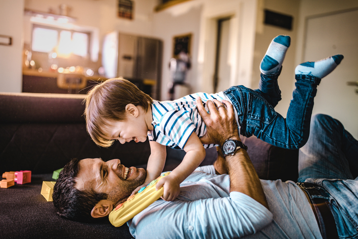 father and son playing inside the house