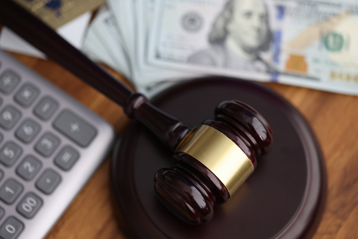 money, a calculator, and a gavel