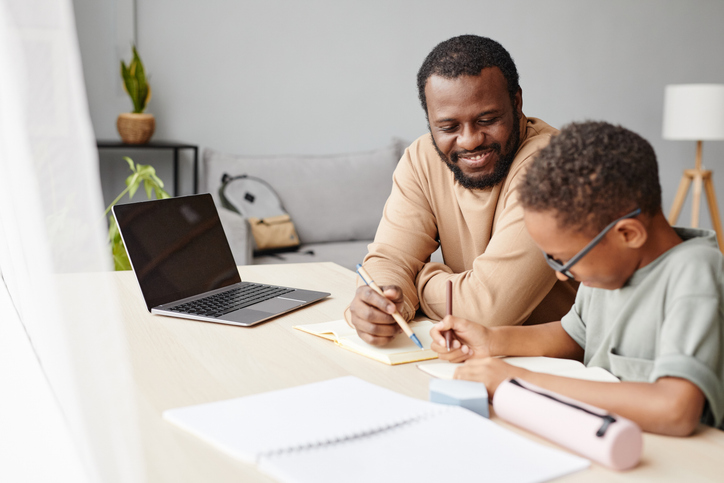father helping son with homework