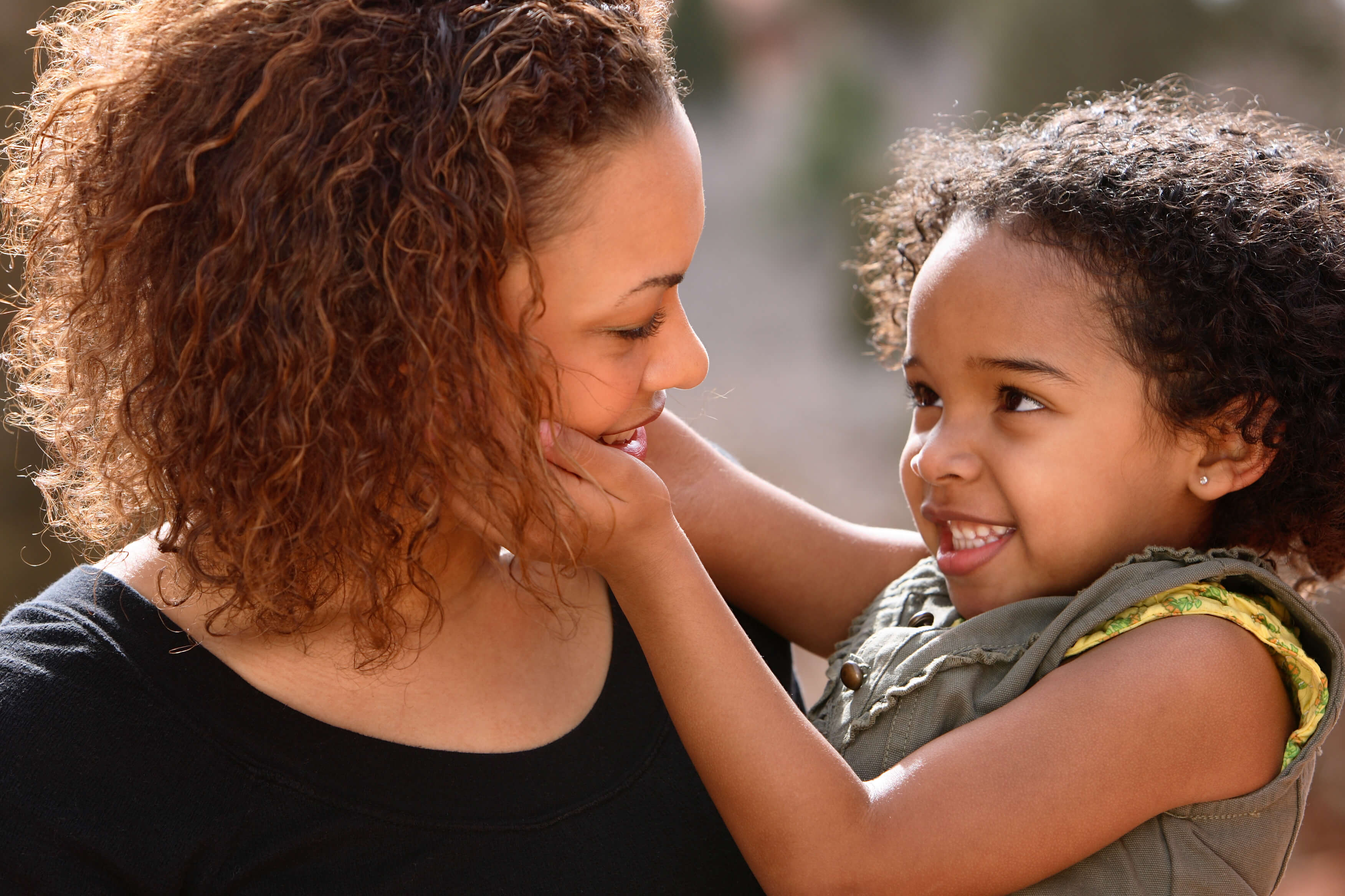 Daughter smiling holding her mom's face