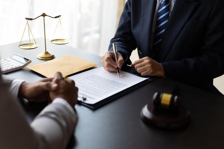 client and lawyer reviewing documents in law office