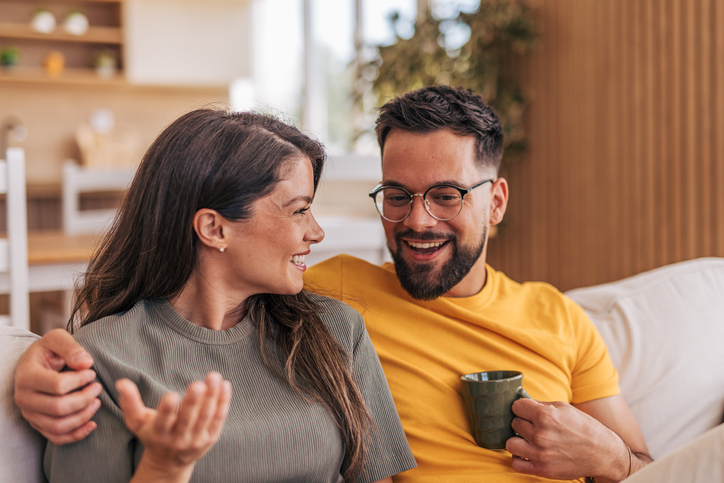 happy couple talking and drinking coffee