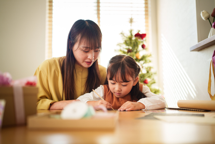 mother helping daughter with homework