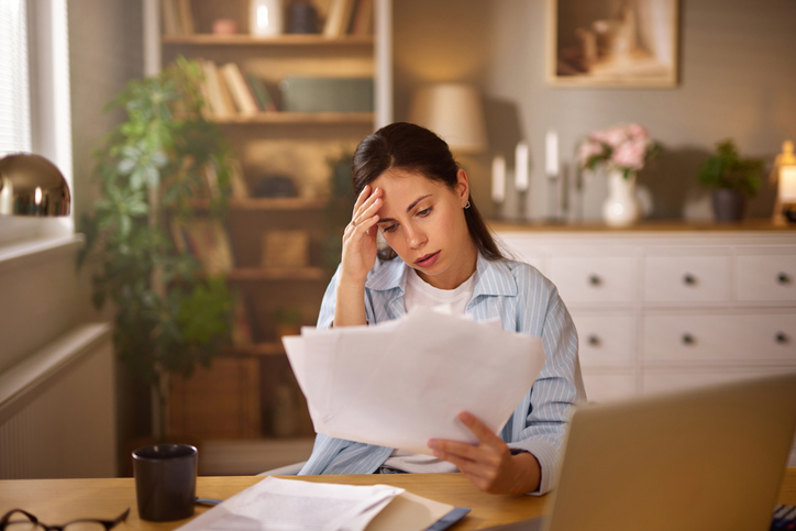 sad woman reviewing documents